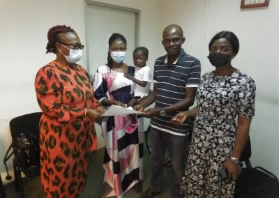 From The Left LHCHF Operational Director, Dr. Mrs Francisca Odeka presenting a P-TAP Medical Grant to a child patient in National Hospital Abuja