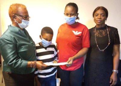 The LHCHF Director of Operations Dr. Francisca Odeka presenting PTAP medical Grant to the Mother of K.E to assist in paying for the treatment of the patient at the National Hospital Abuja 2nd November, 2022