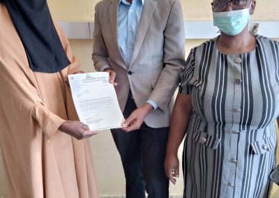 The LHCHF Program Administrator presenting PTAP medical Grant to the Mother of A.A to Support His Medical Treatment  at University of Abuja Teaching Hospital Gwagwalada. He is being supported by a staff of Social Welfare Department of the Hospital 13/01/2023