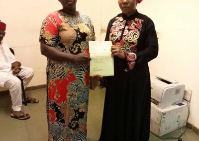 The LHCHF Staff presenting PTAP medical Grant to the Mother of  Mathew Emmanuella to Support Her Medical Treatment  at National Hospital Abuja.