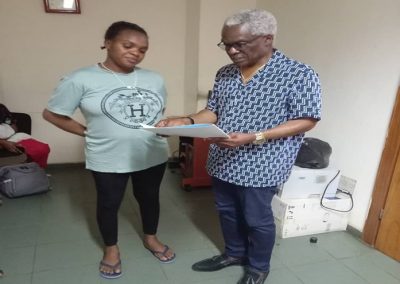 LHCHF CEO/ Founder Dr Benjamin Odeka presenting PTAP Medical Grant to a parent, Mrs Oluwabusiyi for Baby Daramola  to support her medical treatment at National Hospital Abuja – July 2023