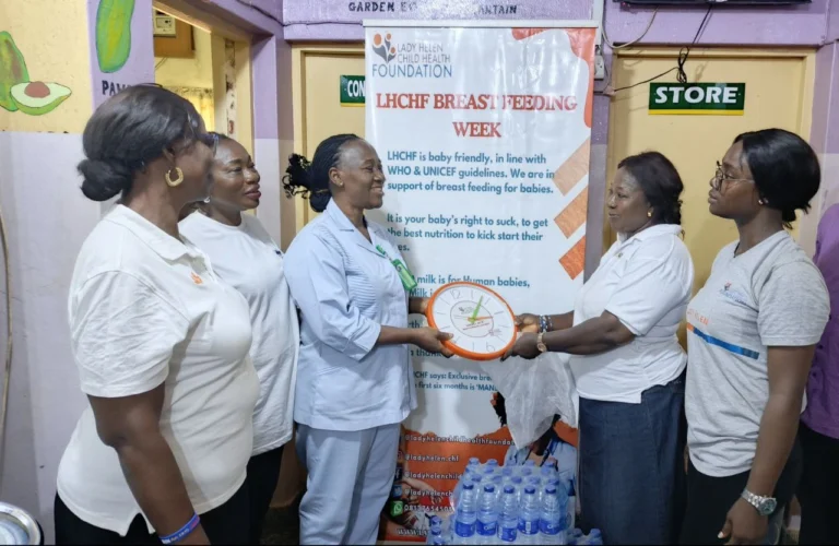 Presentation of a gift to the head of nursing, along with packs of bottled water
