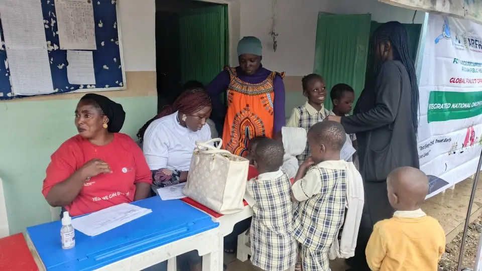 A Hope for survival care giver providing vital medical history of the children to the LHCHF volunteer