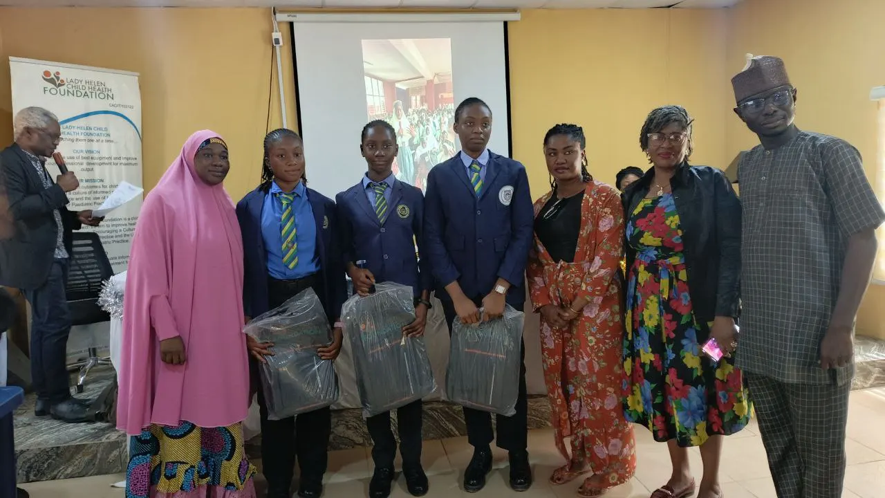 The first runner up students of Police Day Secondary School with bags containing branded notebooks from CWAY Integrated Abuja and branded prizes from Lady Helen Child Health Foundation and the members of the FCT Secondary School Education Board and a coordinator