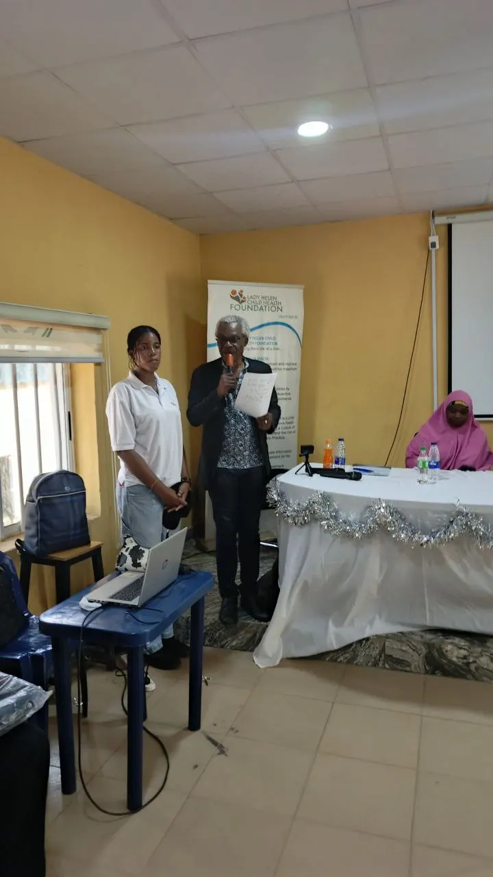 Dr Benjamin Odeka announcing the scores from the debate and stating the winners