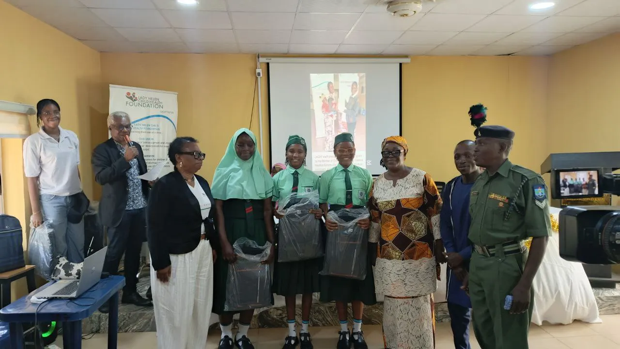 Dr Francesca awarding the winning team - Command Day Secondary School -with bags containing branded notebooks from CWAY Integrated Abuja and branded prizes from Lady Helen Child Health Foundation