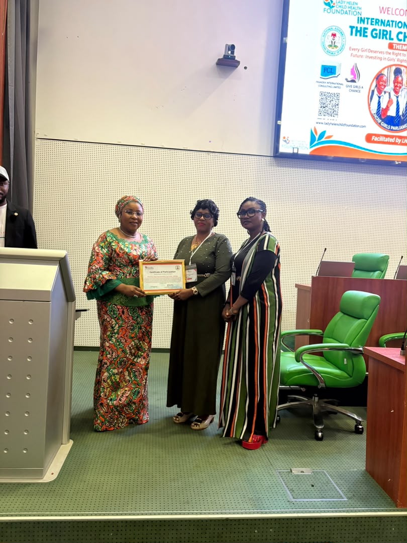 Immediate Past Head of the Civil Service of the Federation presenting certificates to school representatives.